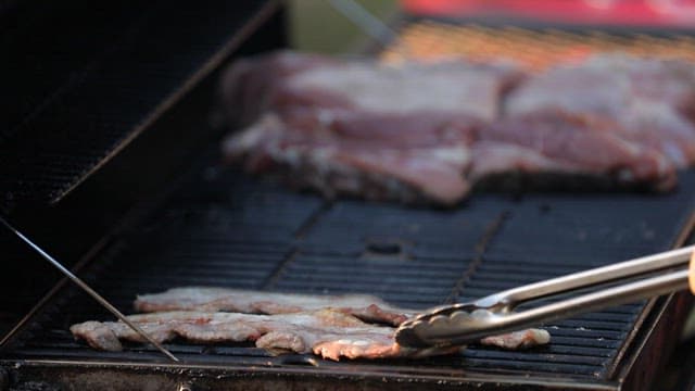 Grilling pork belly on a barbecue grill