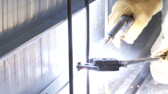 Welding metal rods with sparks flying