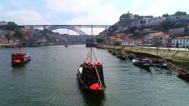 Aerial View of River with Boats and Bridge