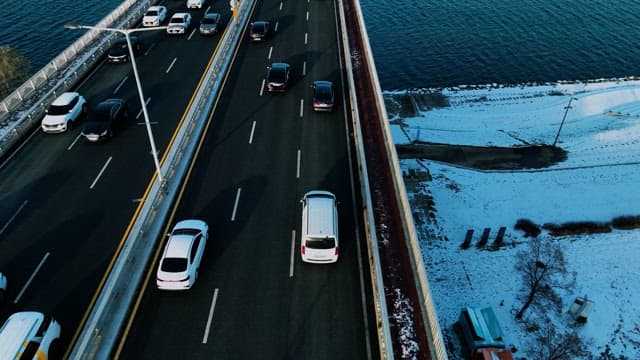 Traffic on a Riverside Bridge in Winter