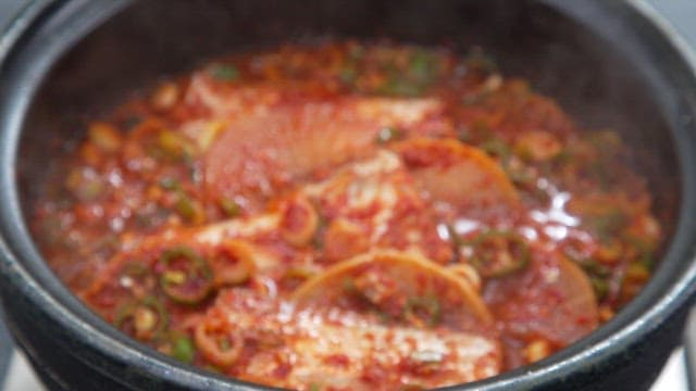 Braised hairtail with radish and spicy seasoning boiling in a pot