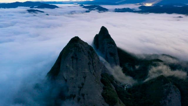 Mountain Peak Above Sea of Clouds at Dawn