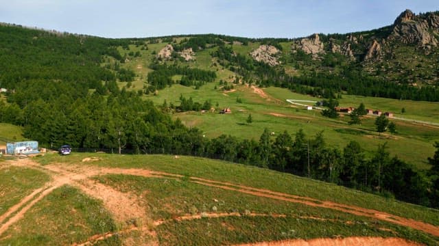 Vast green landscape with hills and trees