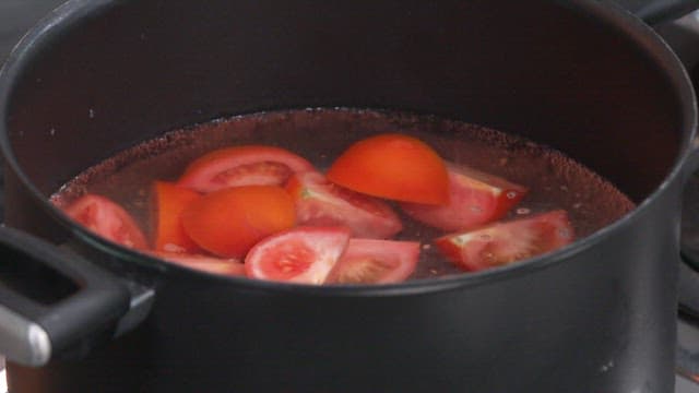 Sliced Tomatoes and Onions Boiling in a Pot