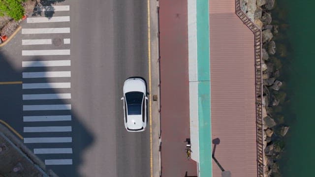 Peaceful riverside promenade and a traffic-carrying road