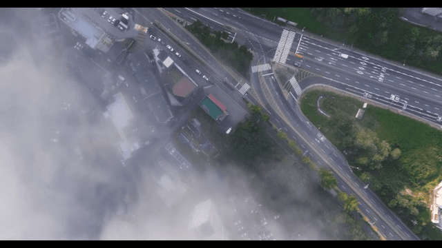 Landscape with buildings and roads under clouds