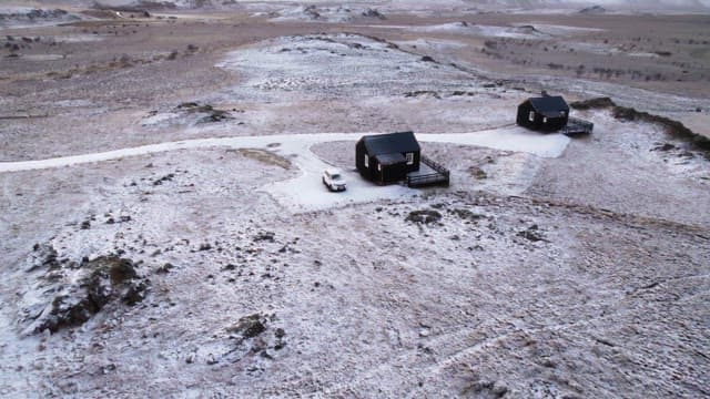 Snow-covered landscape with cabins