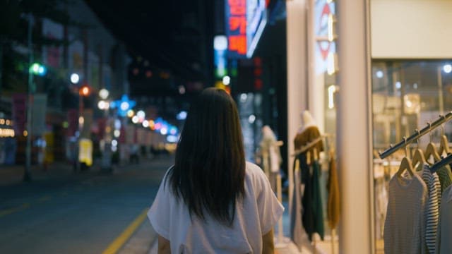 Woman Contemplating the City at Night