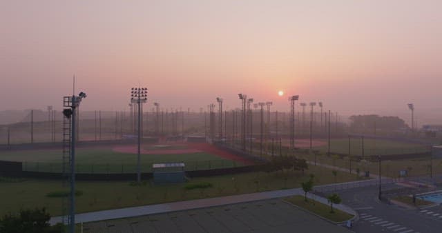 Baseball field at sunset with mist