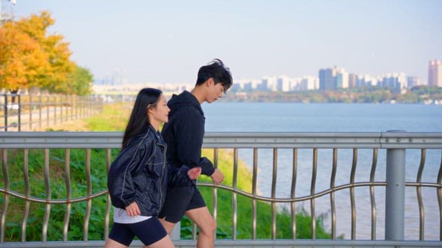 Couple jogging on a jamsu bridge