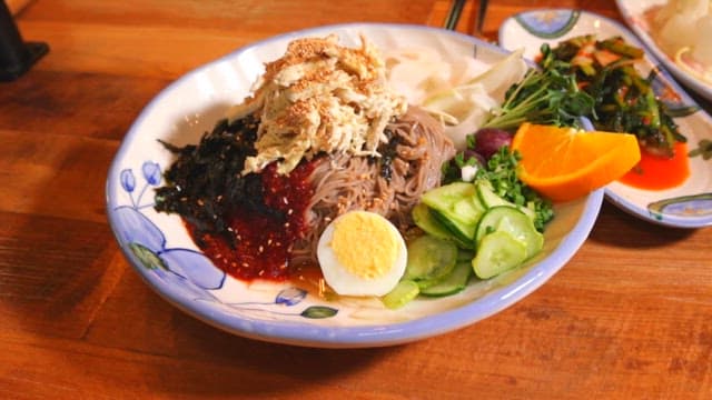 Appetizing Bibim Naengmyeon on a Wooden Table