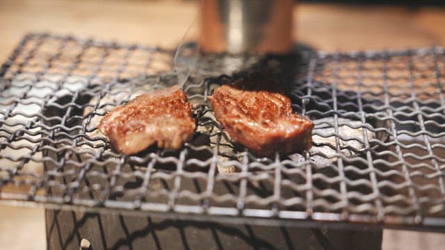 Meat sizzling on the fire grill