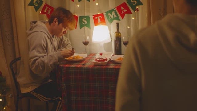 Man eating in cozy room decorated with Christmas decorations