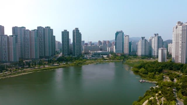 Aerial view of a city with high-rise buildings and a lake