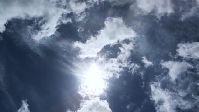 Sky with Flowing Clouds and Sun in the Middle of the Day