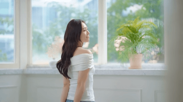 Woman enjoying a quiet moment by the window in the morning sunshine