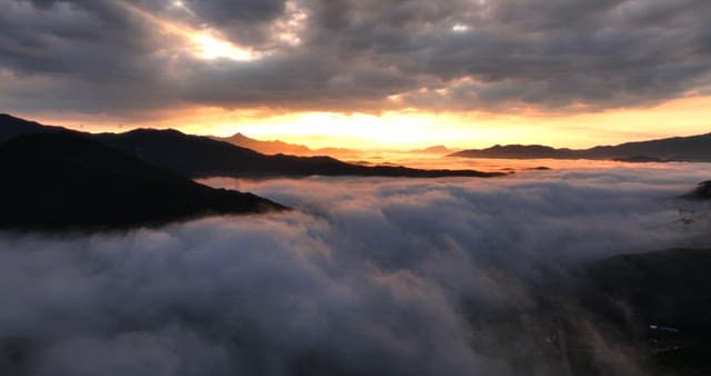 Sunrise over mountains with clouds
