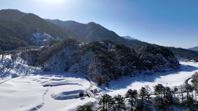 Snow-Covered Valley and Mountain in Winter
