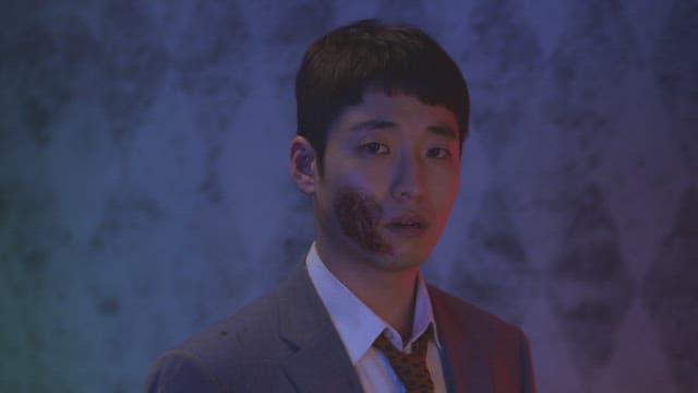 Man with a large scar on his face grumbles