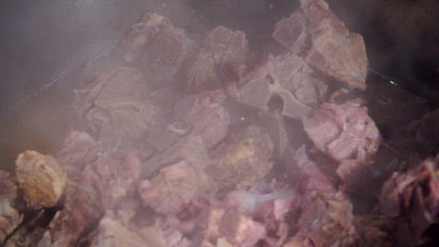 Pork backbones cooking in a sot