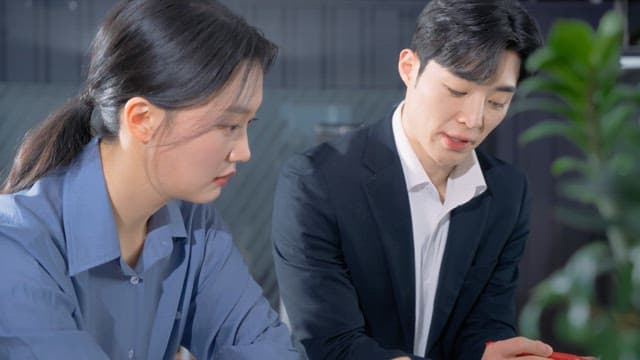 Two colleagues discussing documents