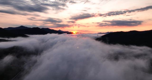 Sunrise over mountains with clouds