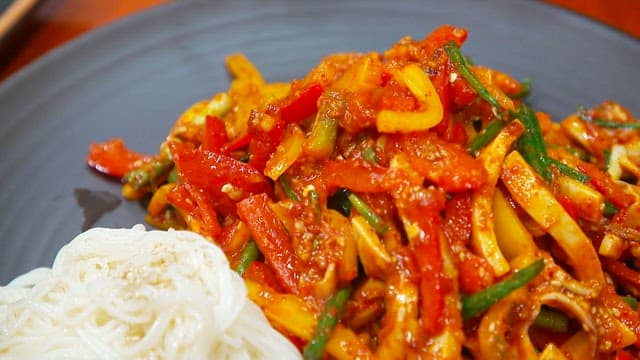 Spicy squid marinated in vinegar and somen noodles on a plate