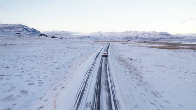 Car driving through a snowy landscape