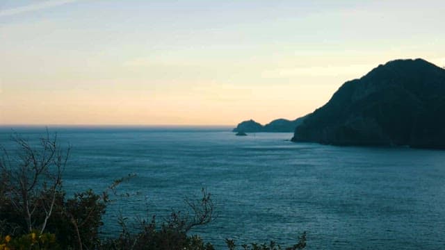 Serene Seascape at Dusk with Lush Hills
