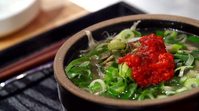 Bowl of chicken soup with red marinade
