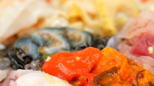 Fresh sea pineapple being picked up with chopsticks