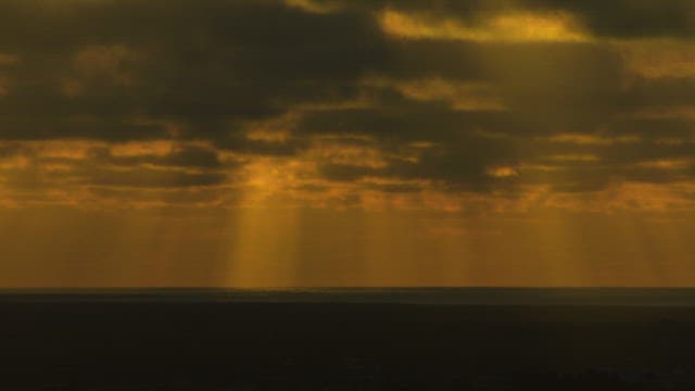 Rays of Sunlight Through Clouds at Dusk