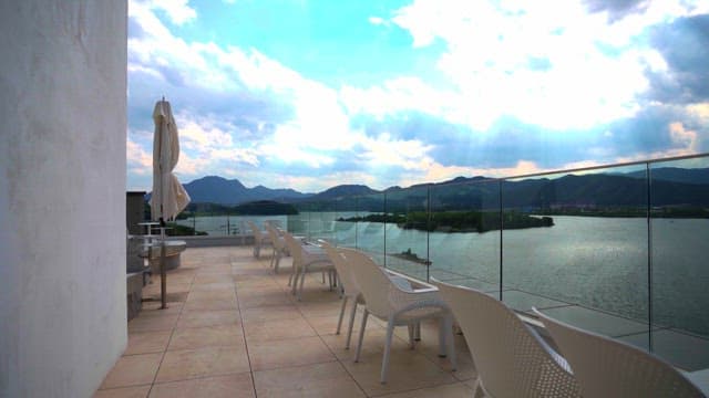 Peaceful outdoor terrace overlooking mountains and river on a cloudy day
