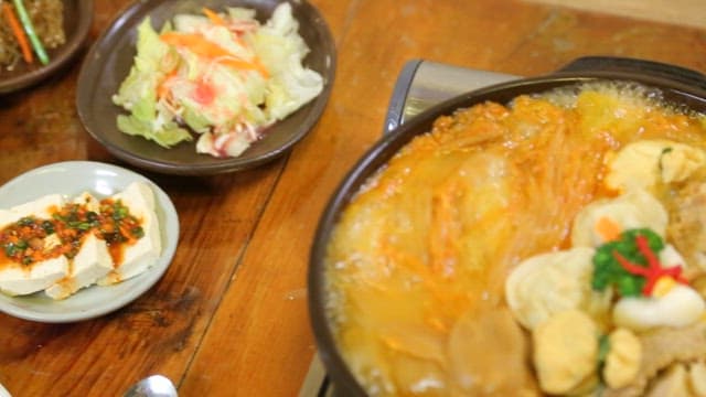 Braised aged kimchi and pork bubbling on the burner