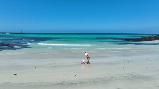 Mother and child playing on a serene beach