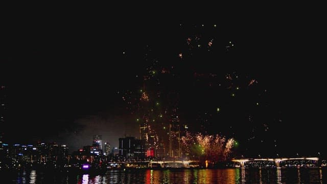 Fireworks display over city skyline at night