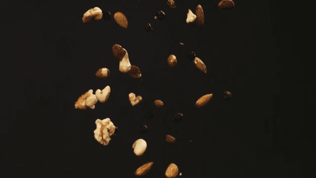 Nuts and dried fruits falling in the air