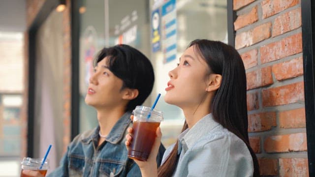 Couple enjoying iced coffee outdoors