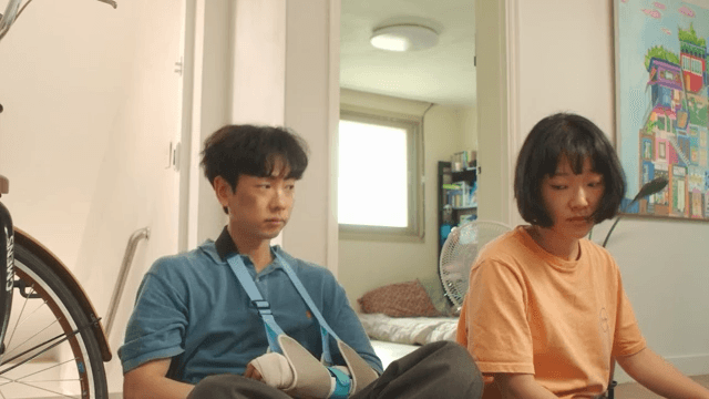 Woman and Man lying in living room with arm cast