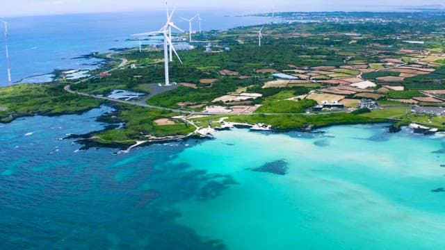 Coastal Wind Turbines Overlooking Emerald Waters