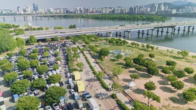 Bustling riverside park with city skyline