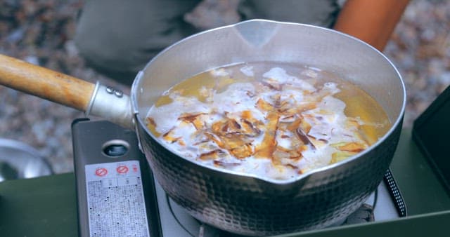 Cooking food in a pot outdoors