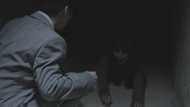 Man fails to help a woman who is being dragged into the darkness of the hallway