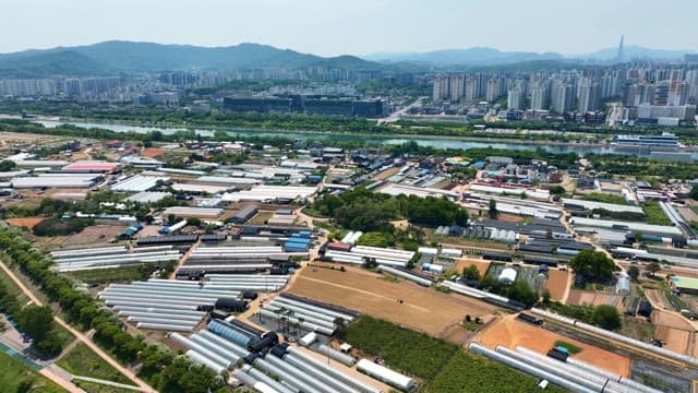 Aerial view of greenhouses near a city