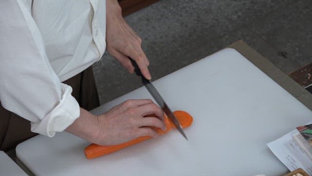 Slicing a Carrot on a Cutting Board in the Kitchen