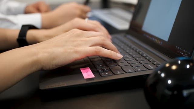 Professional typing on a laptop keyboard