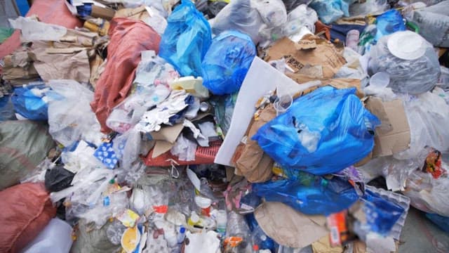 Large piles of garbage at a recycling facility