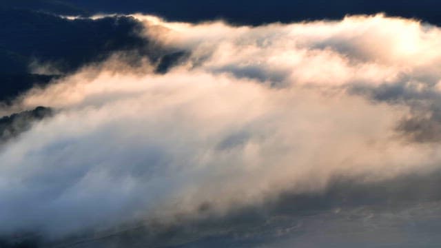 Clouds drifting over mountain peaks