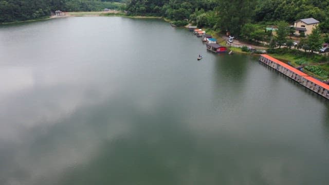 Peaceful fishing spot with lush greenery and calm waters