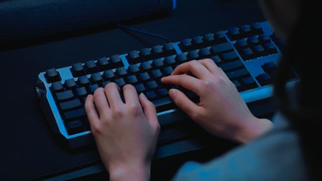Person Typing on a Mechanical Keyboard